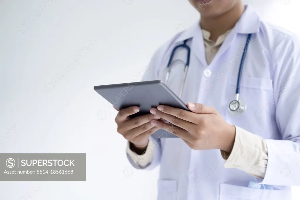 Doctor using a digital tablet computer at work.