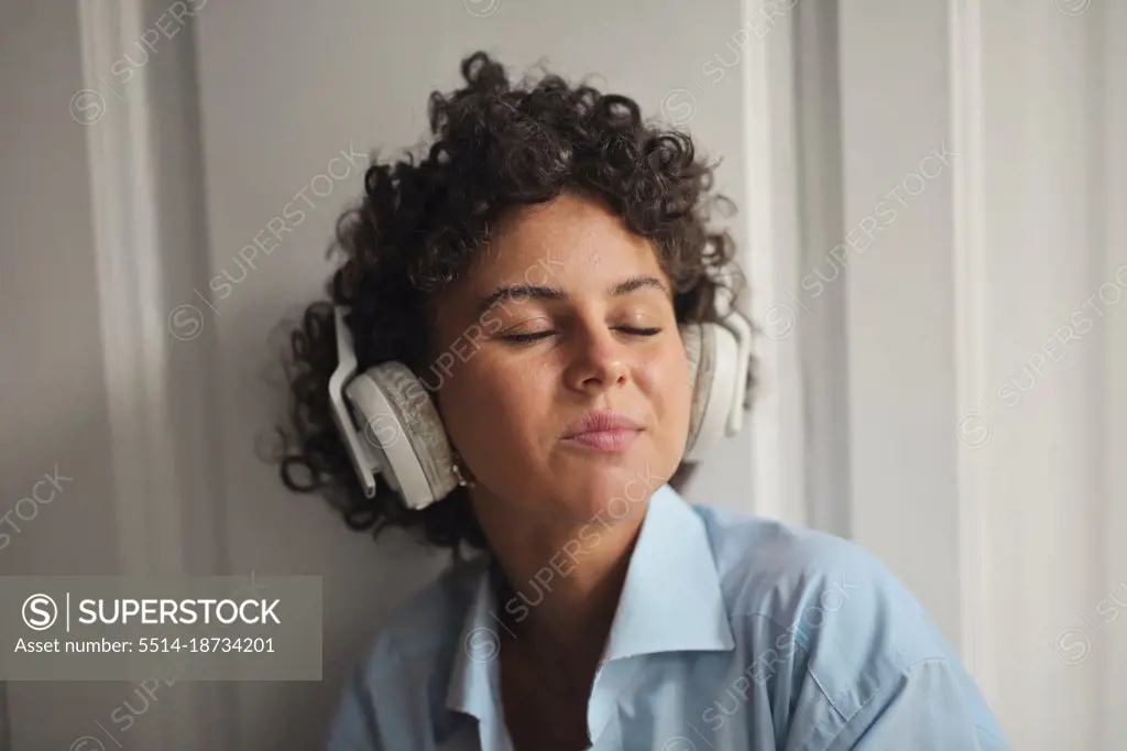 young woman listens to music with headphones
