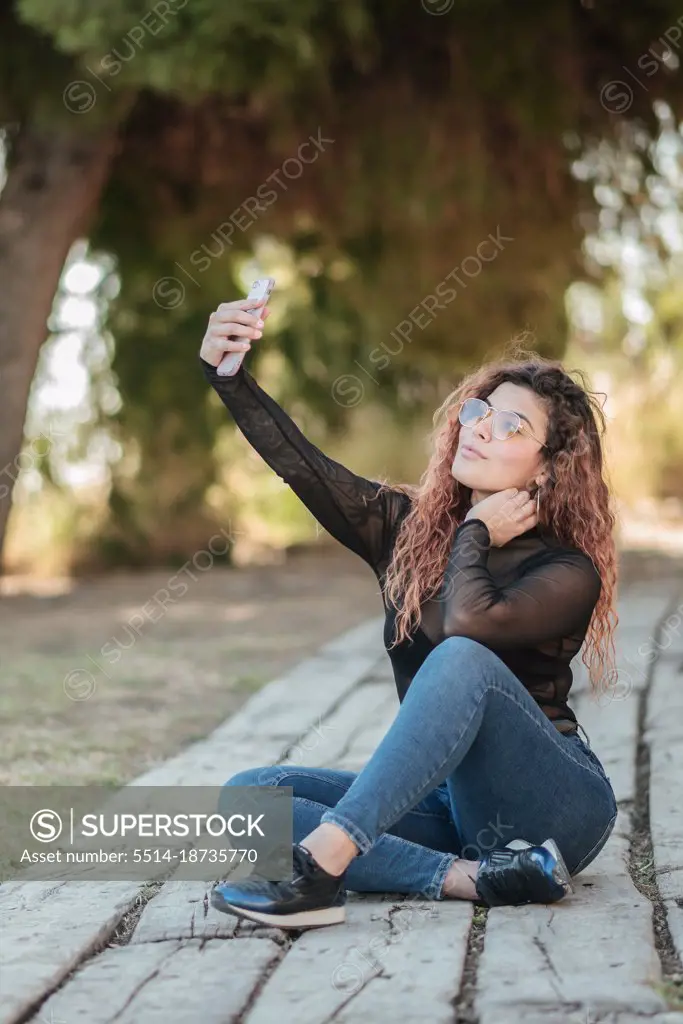 pretty latin woman  doing smarphone  outdoors