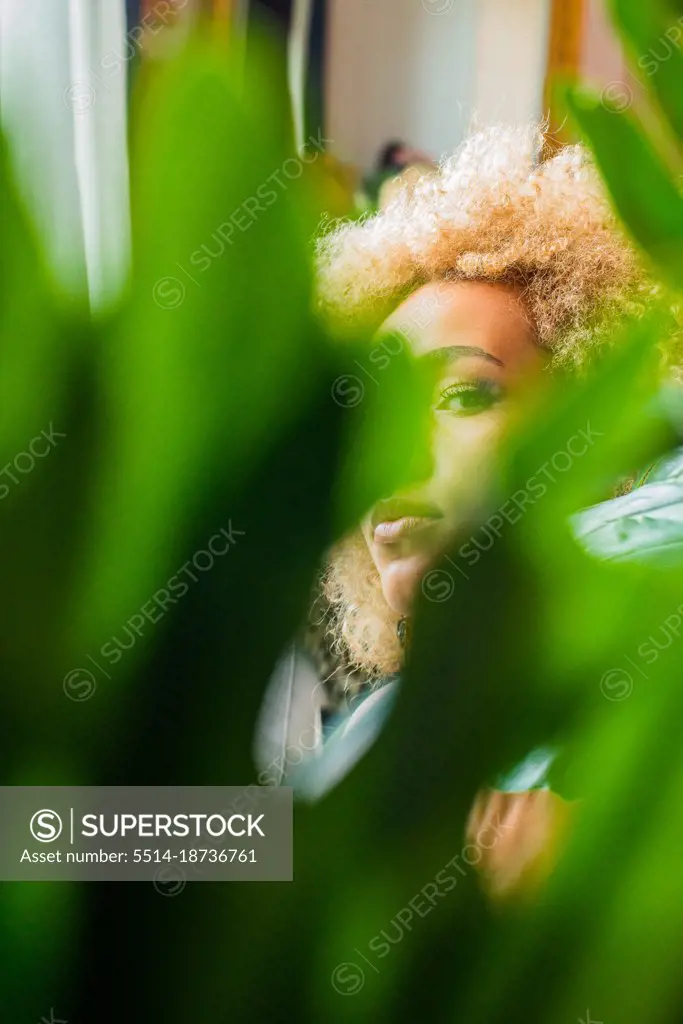 looking seductively through the plants