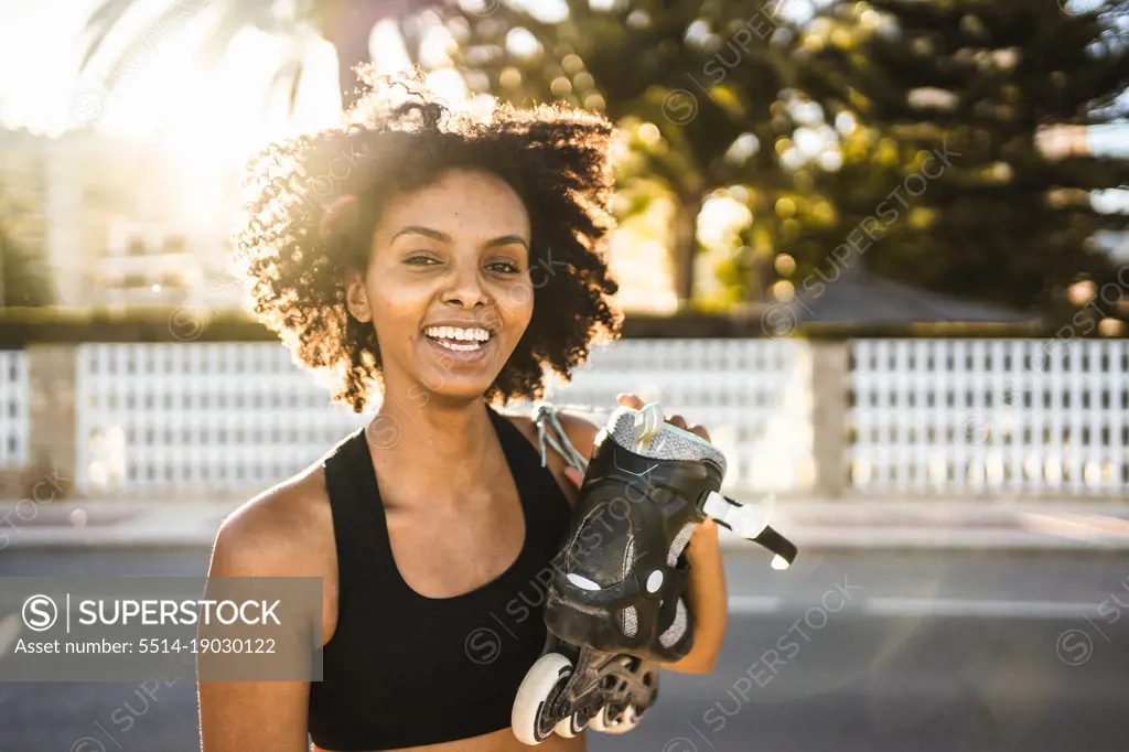 Beautiful young black woman happy to go out with her roller skates
