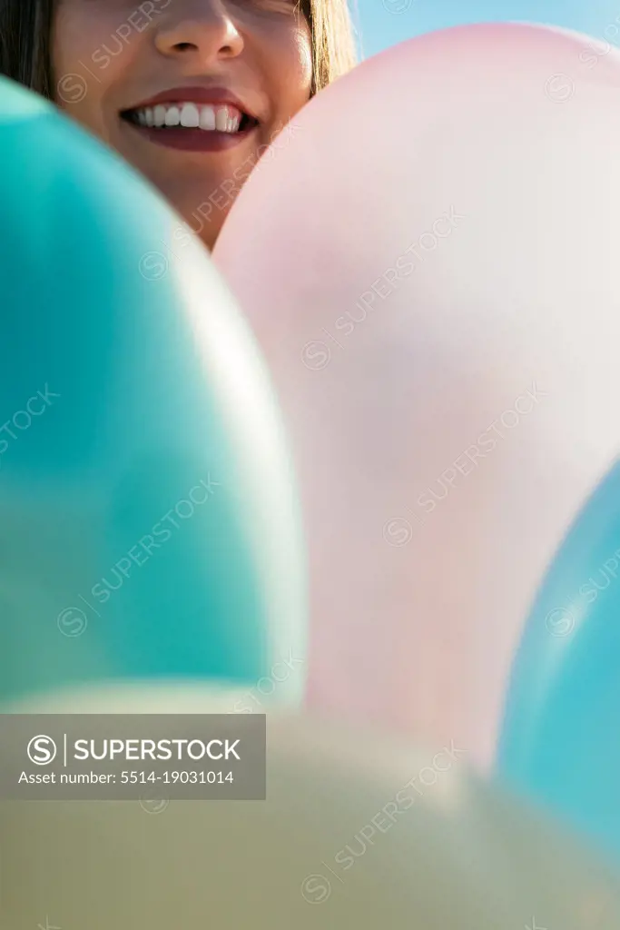 Anonymous Woman Covering Her Face With Balloons
