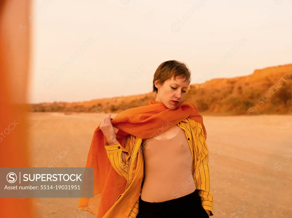 woman with orange cloth in desert