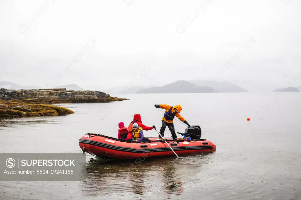 A family in a Zodiac boat in calm water