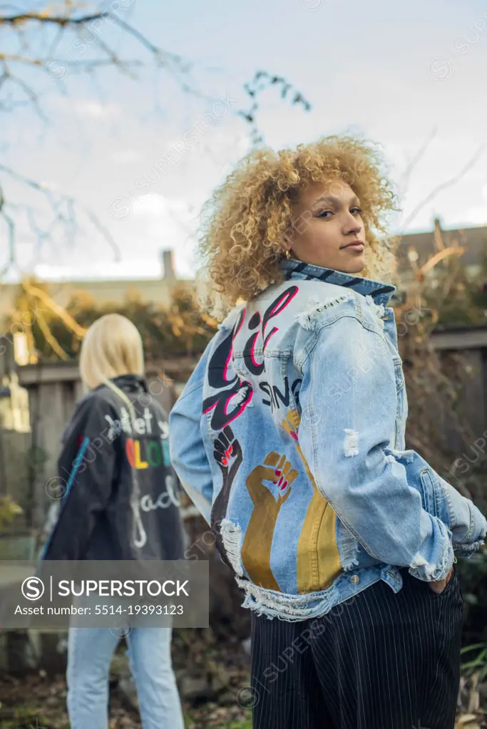 Confident girl in hand painted jean jacket