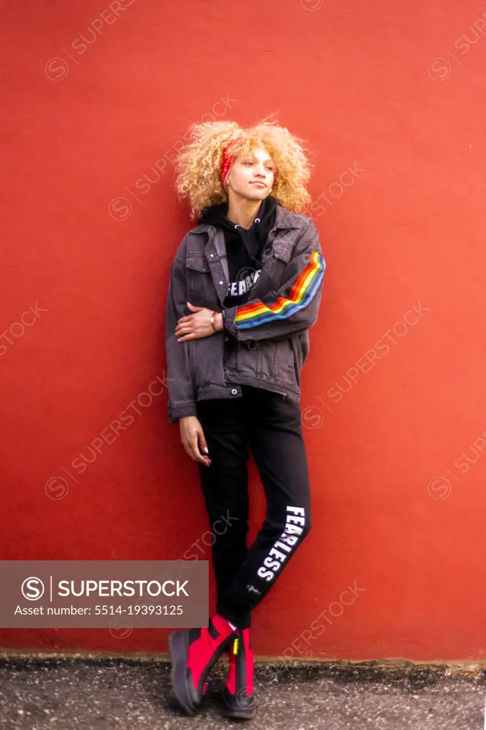 Blond haired woman  against red wall