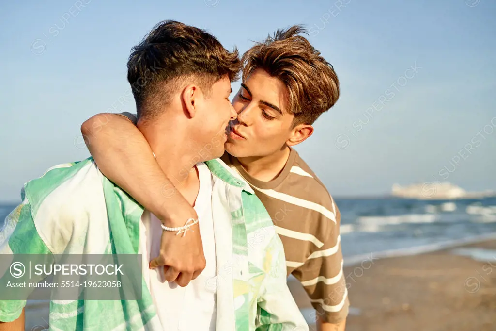 Intimate moment of a gay couple on the beach