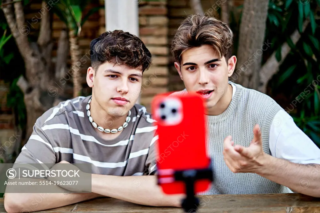 Gay Couple influencers Recording Podcast Using Phone