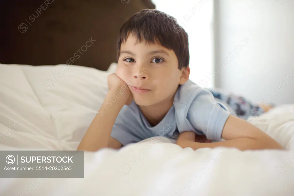 A Young Boy In Pajamas Looking at Camera