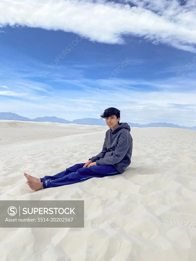 A Teen Boy sitting on the Sand Dune
