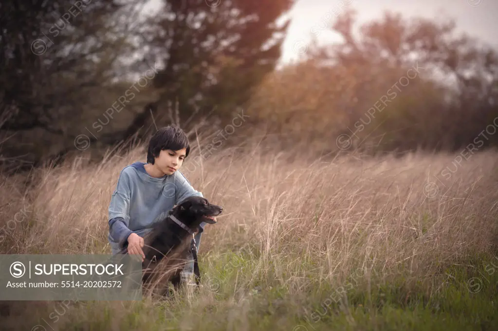 A Boy and His Dog In a Field