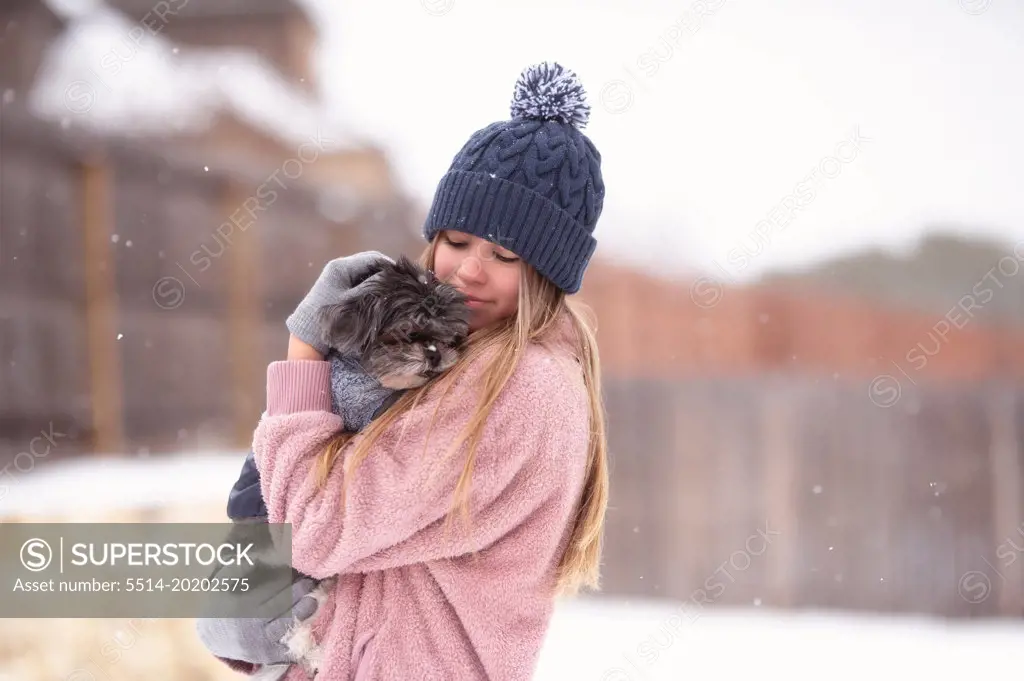 A Girl Petting Dog In the Snow