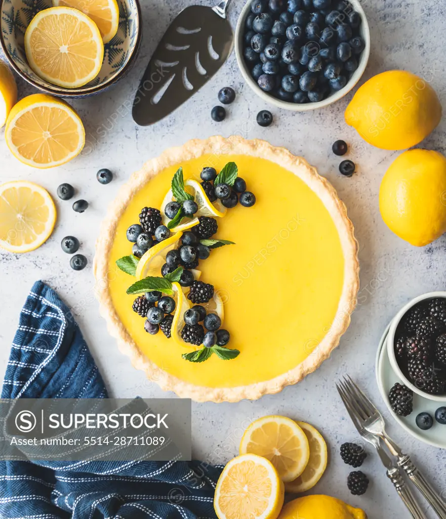 Top view of lemon tart with blueberry and blackberry garnish.