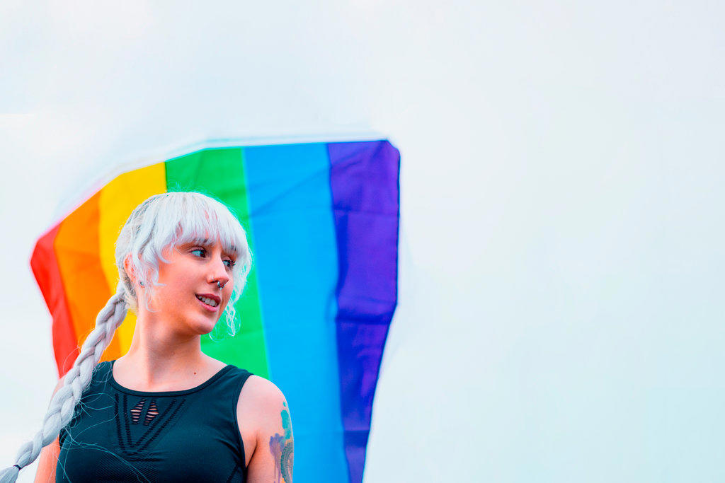 Lesbian girl holding LGBT flag at gay parade
