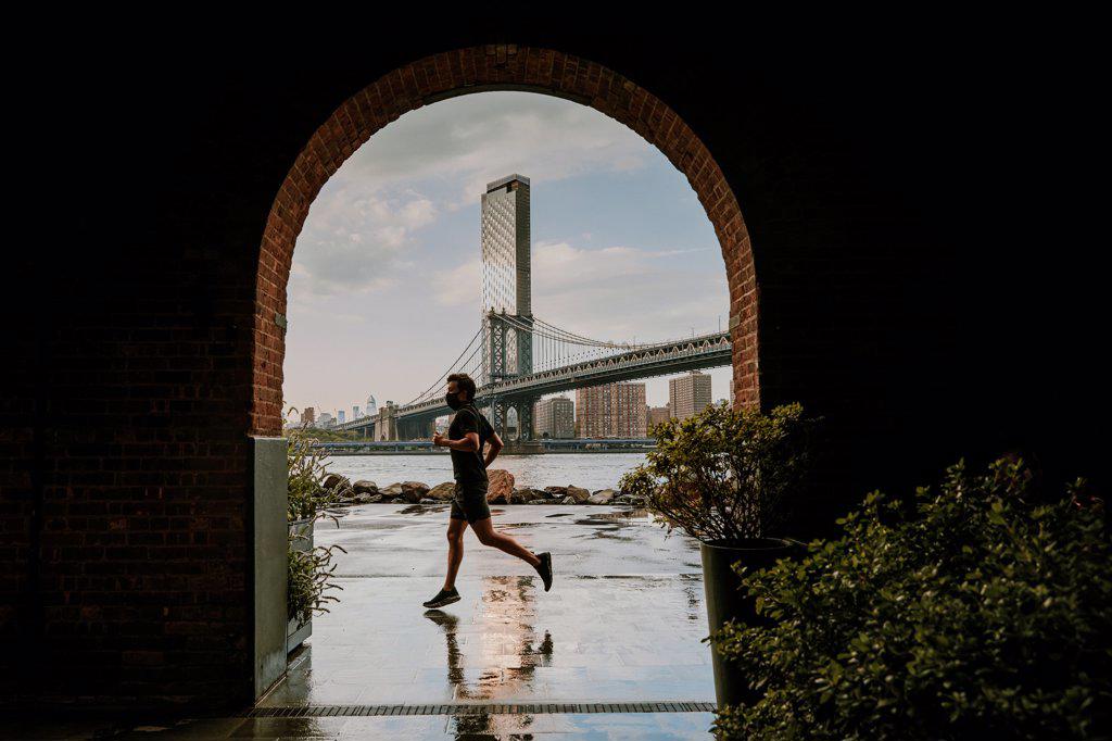 Silhouette of man running against skyline.