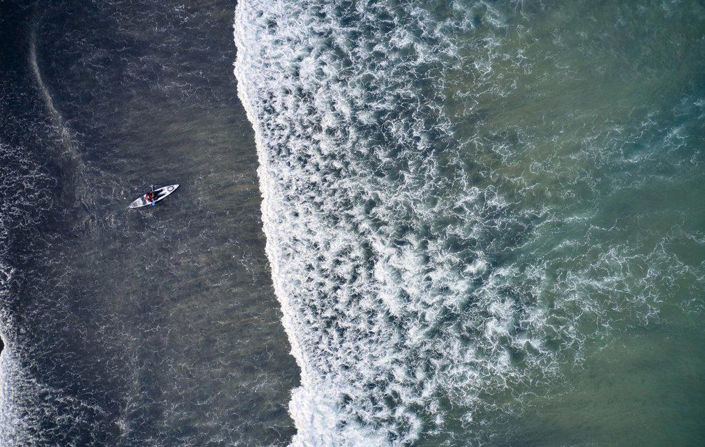 Cold waves of ocean with lonely kayaker