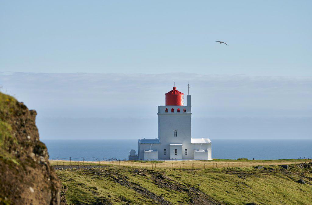 Lighthouse on seashore in morning