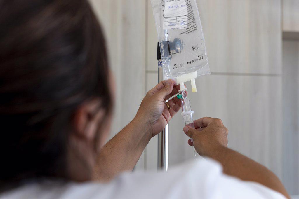 a caregiver checks an infusion