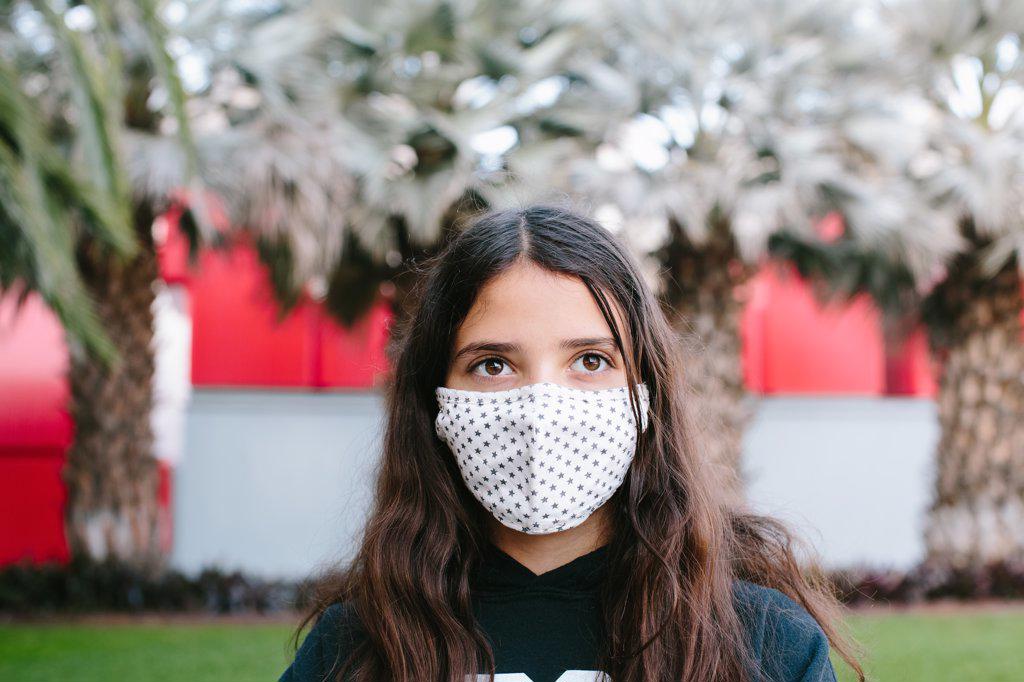 Tween Girl Wearing A Cloth Face Mask Outside Looking Yonder