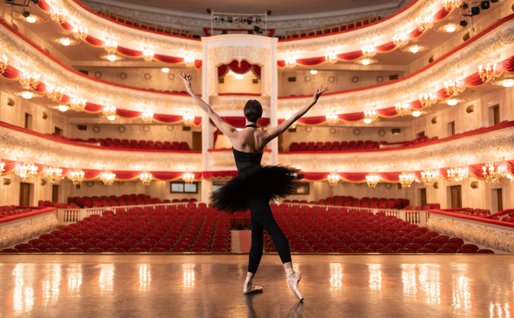 Anonymous ballerina finishing performance in empty theater