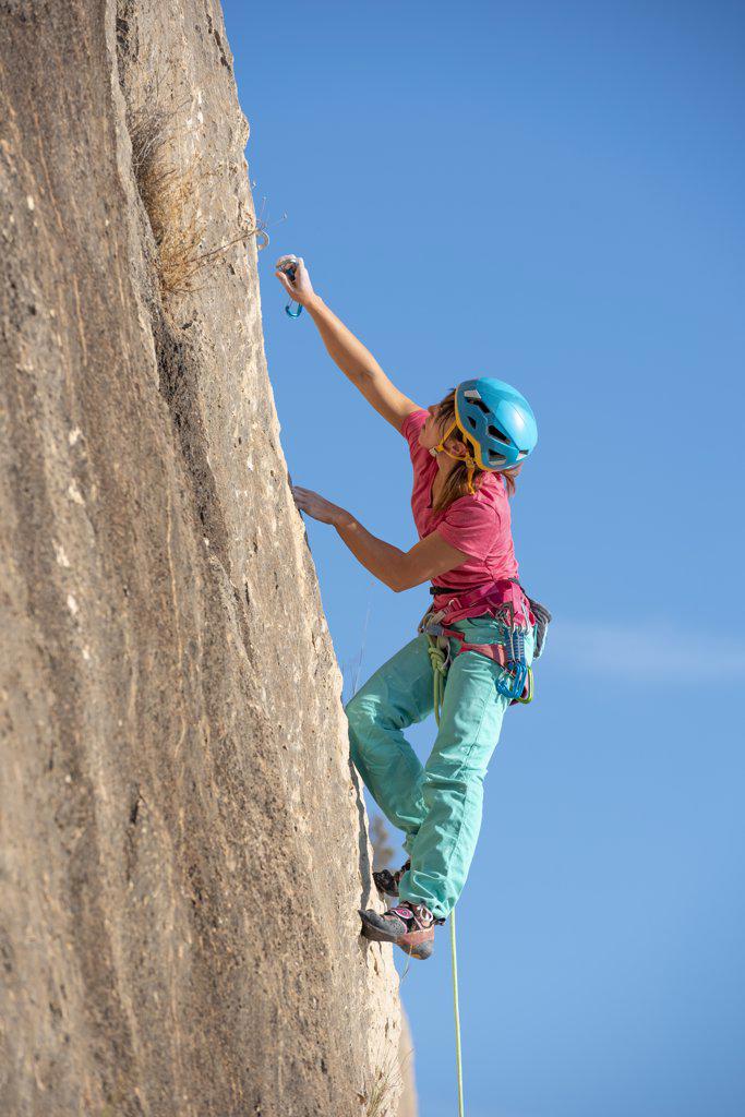 Female rock climber in Toix Est, Calpe, Costa Blanca, Alicante Province, Spain