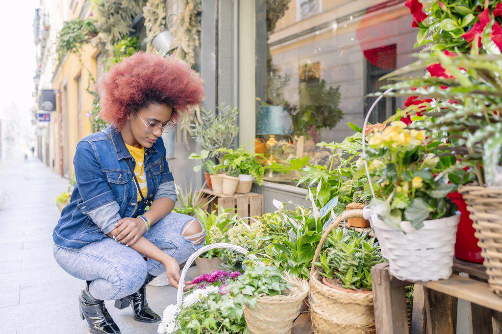 woman with afro hair in a flower shop