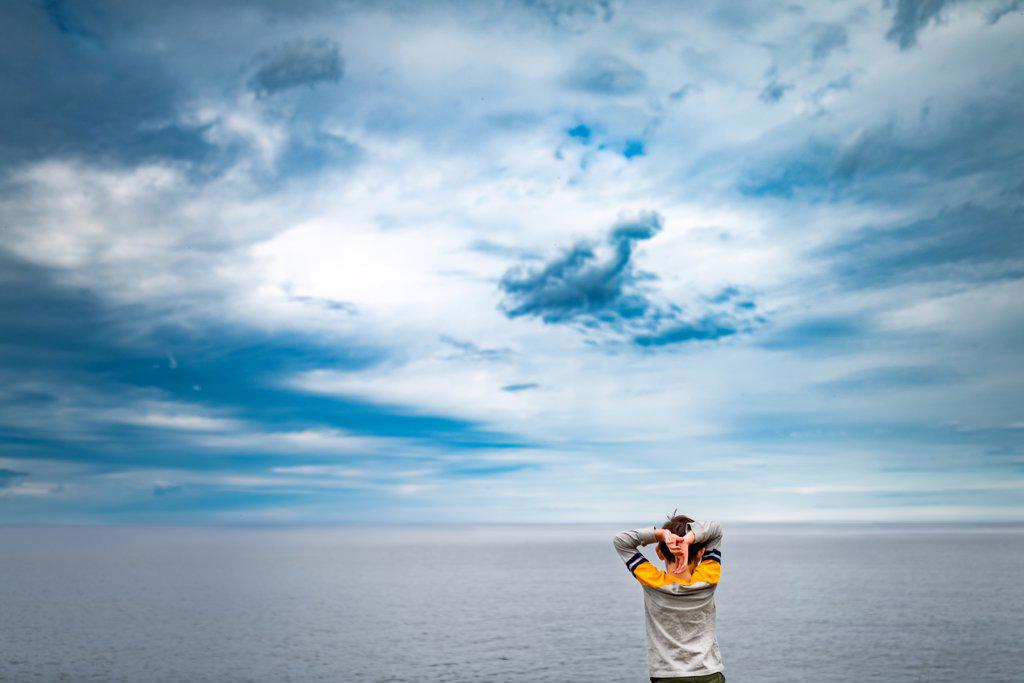 small boy overlooking the horizon on Lake Superior in Michigan