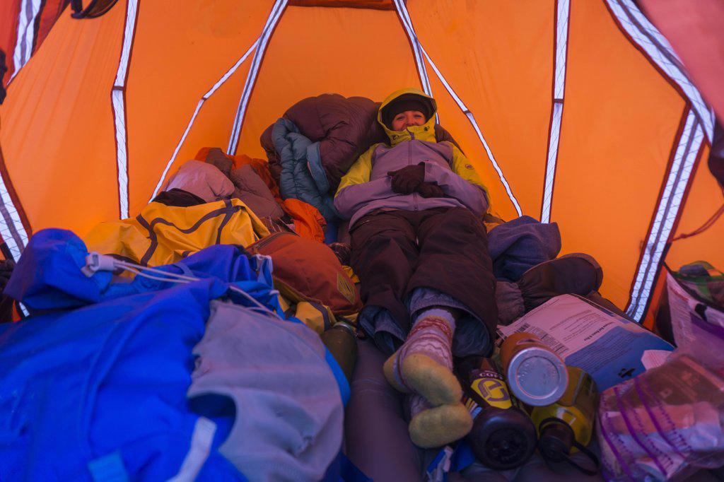 Female in tent smiling while winter camping