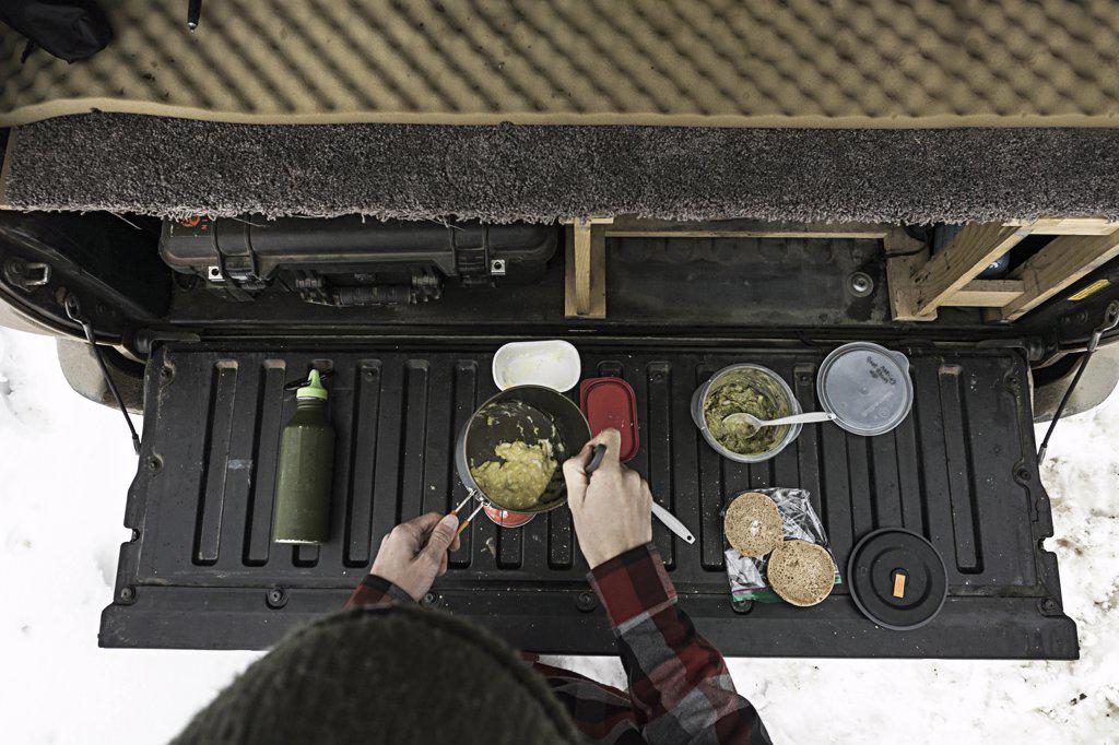 Cooking breakfast on tailgate of truck in winter