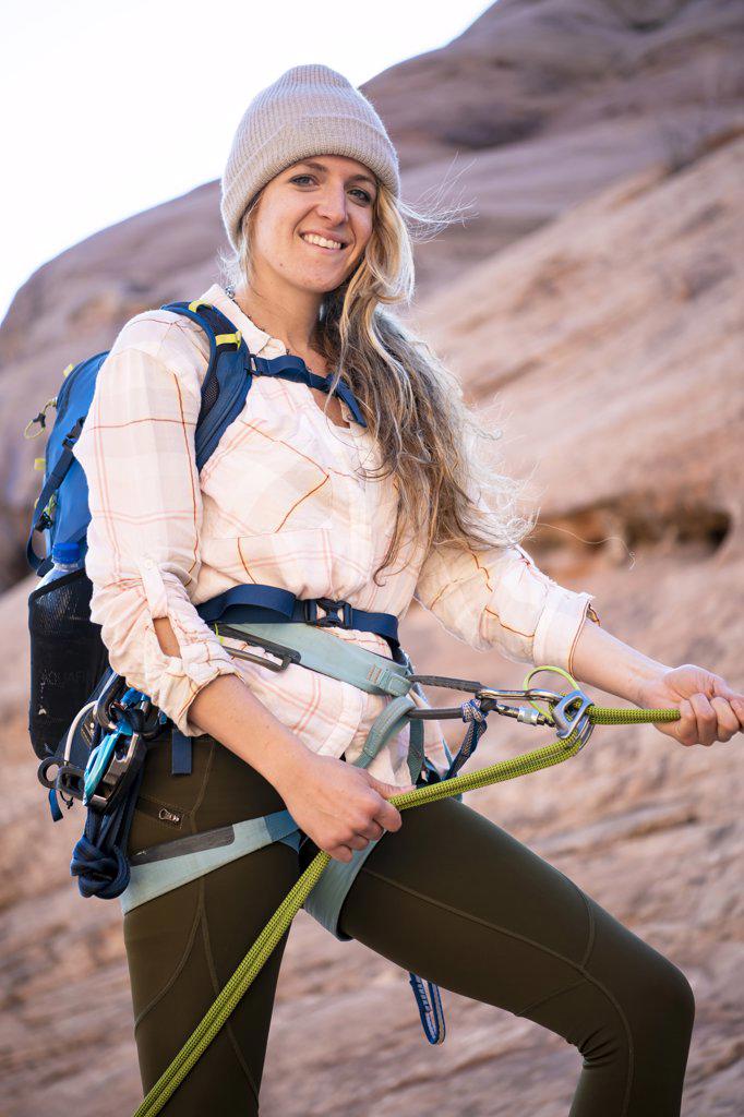 Smiling young woman canyoneering on mountain