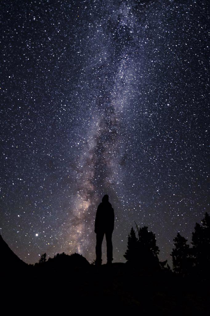 Silhouette woman standing against beautiful star field at night