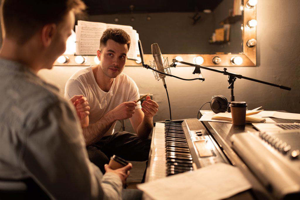 Musicians talking during break in studio