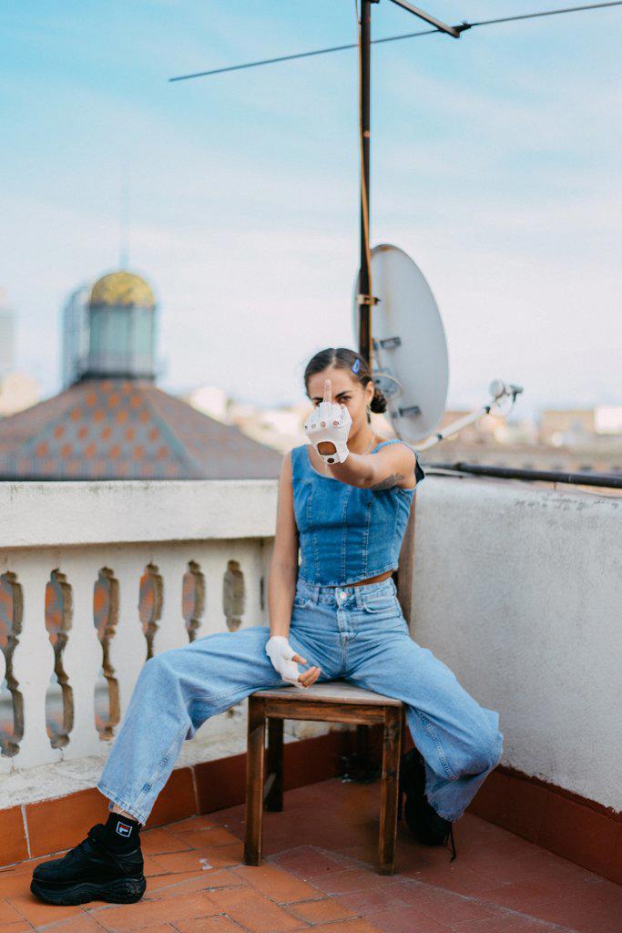 woman dressed all in jean on a terrace in barcelona