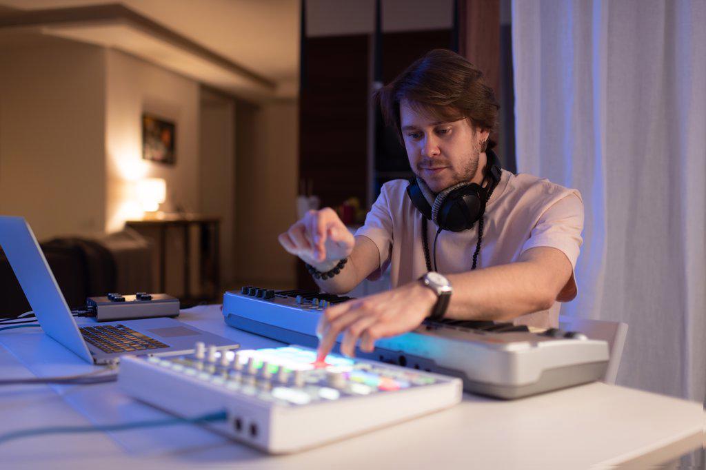 Male DJ creating music at home