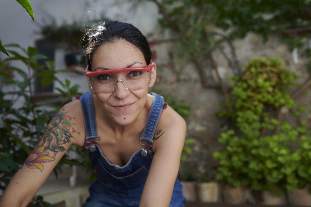 A smiling young woman with safety goggles looking at the camera.