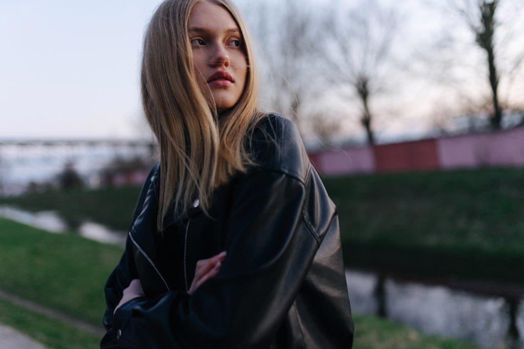 Woman in a leather jacket at sunset