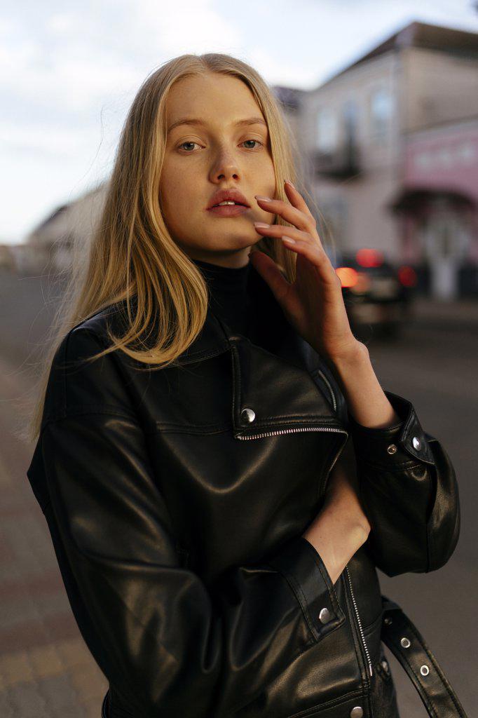 Stylish blonde woman with in leather black jacket