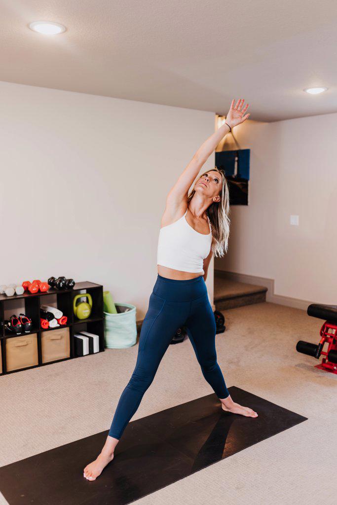 Woman does yoga in her home gym