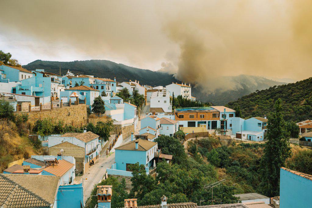 Disaster, wild fire. Town in Spain evacuated. Nearby forest fire.