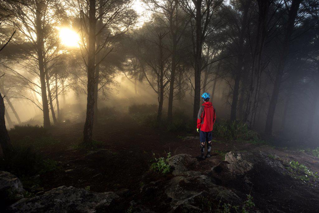 Young mountain biker in a beatiful foggy morning in Spain