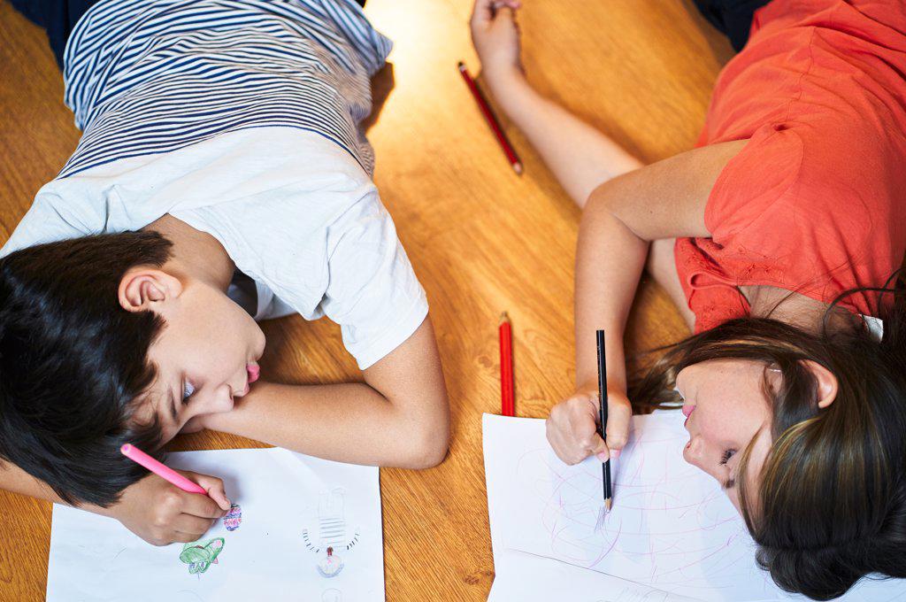 Boy and his sister drawing having fun at home