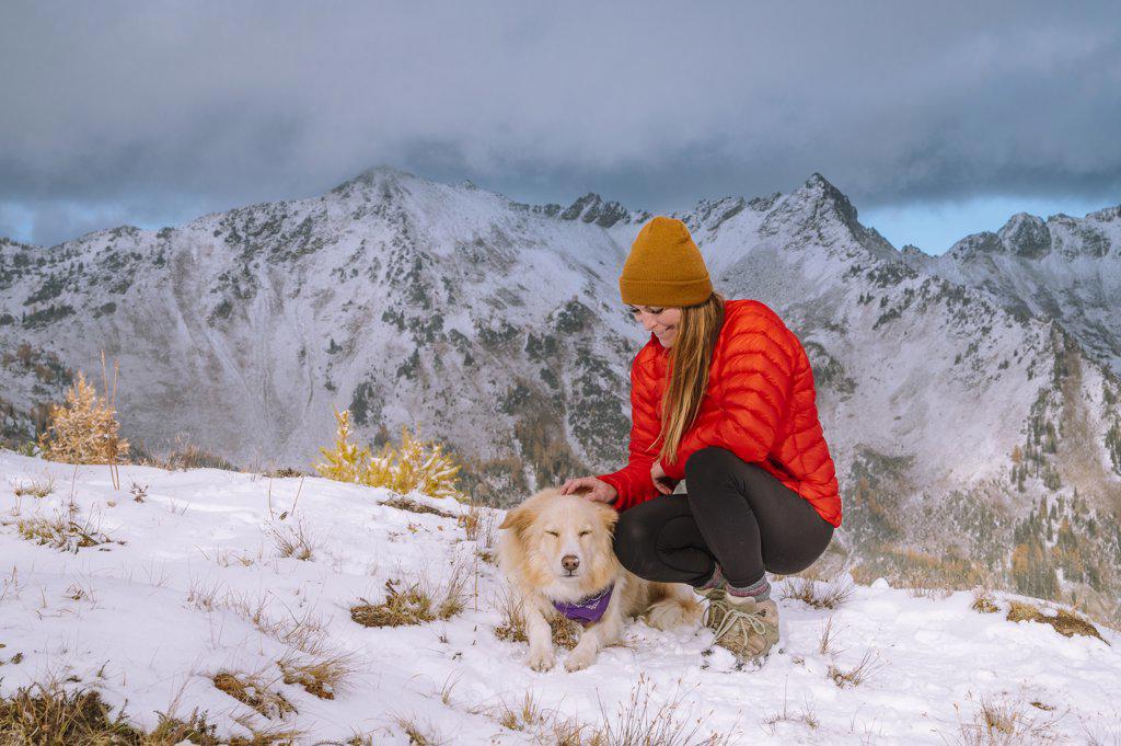 Petting a Cute Fluffy Dog On a Snowy Mountain Top