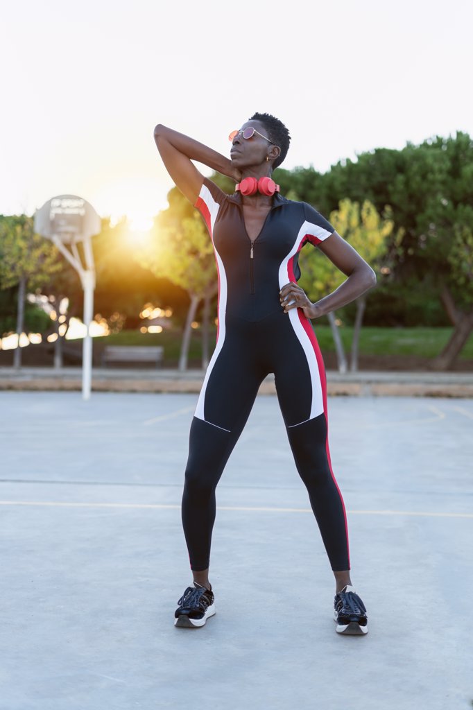 Afro american woman standing in sportswear at sunset