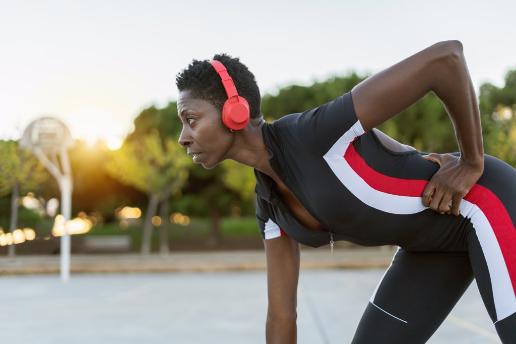 Portrait of african american female exercising and listening music