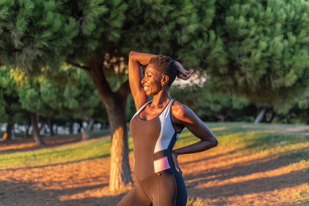 Beautiful afro american female posing after training workout at sunset