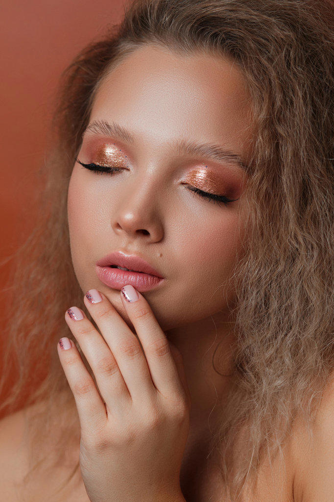 Relaxed girl with beautiful manicure and makeup