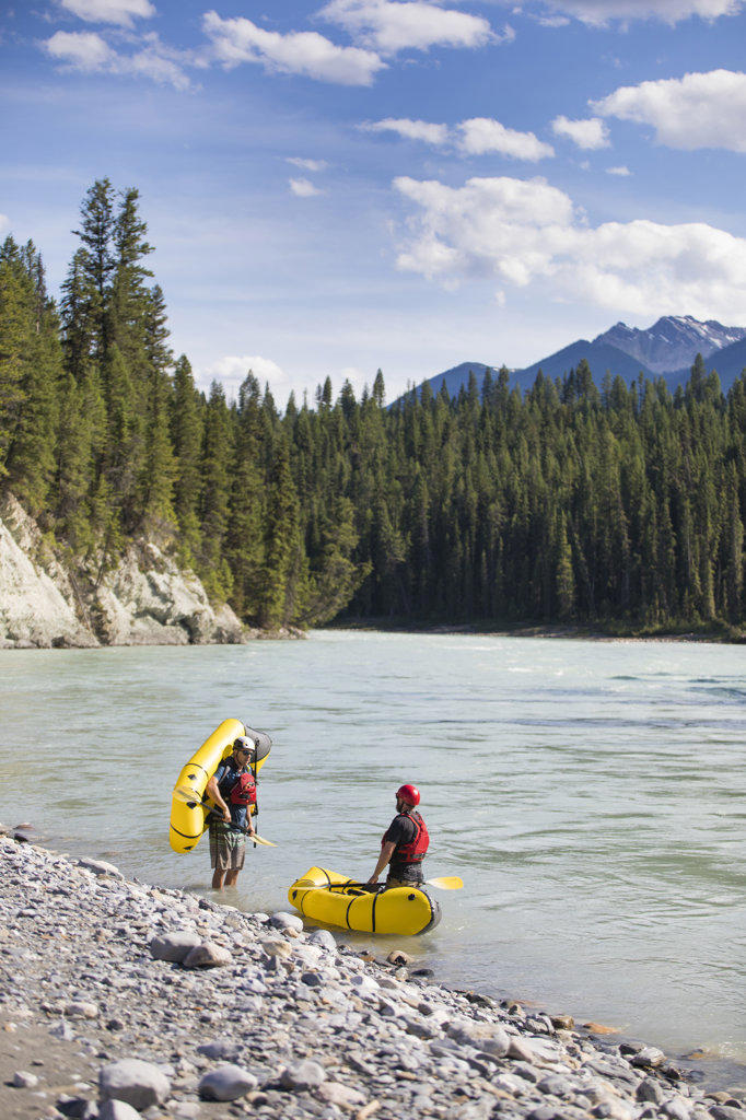 Paddlers stop at the edge of a scenic river, B.C. Canada.