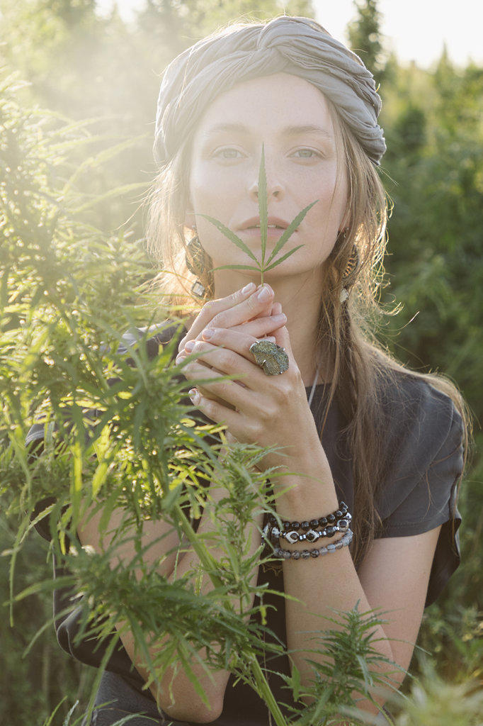 Woman in the Cannabis plant, Girl standing with Marijuana or Hem