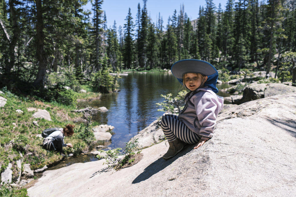 Girl resting on a rock near Sopris Lake, Colorado