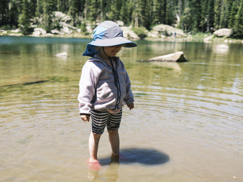 Girl standing in the shallow water of Brady Lake, Colorado
